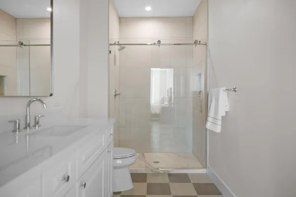 a bathroom with a granite countertop sink toilet and shower