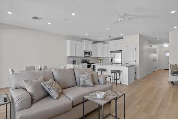 a living room with furniture and kitchen view
