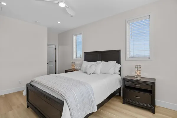 a bedroom with a bed and a night stand