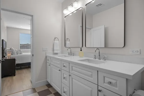 a bathroom with a sink double vanity and a mirror