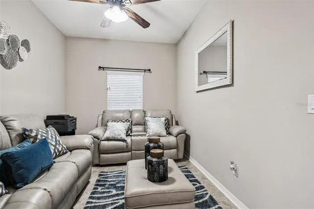 a view of a dining room with furniture and a chandelier
