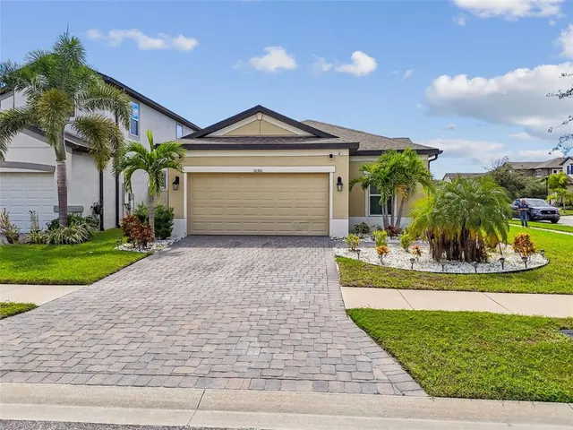 a front view of a house with a yard and garage