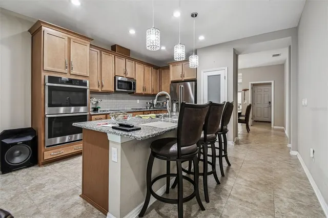a living room with furniture a chandelier and a coffee table