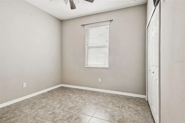 a view of a livingroom with an empty space and a window