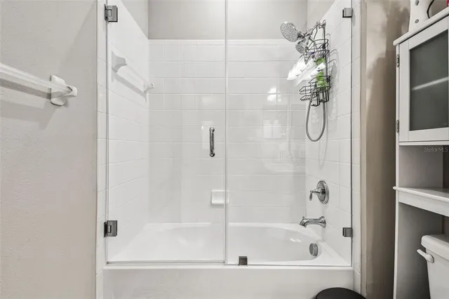 a bedroom with a large bed and a flat tv screen on a dresser