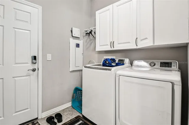 a view of a dining room with furniture a chandelier and wooden floor