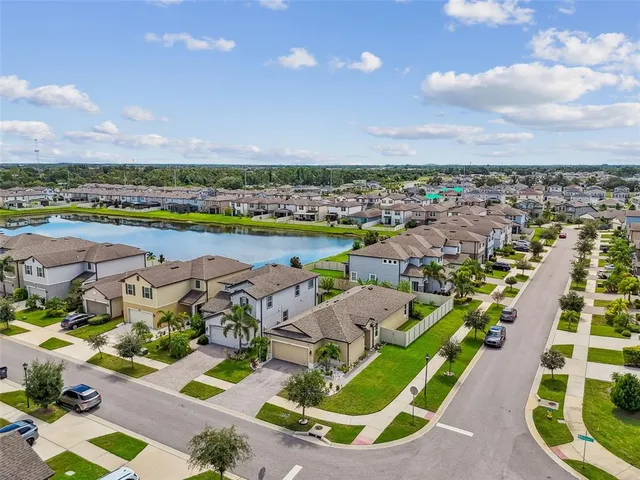 an aerial view of residential houses with outdoor space and swimming pool