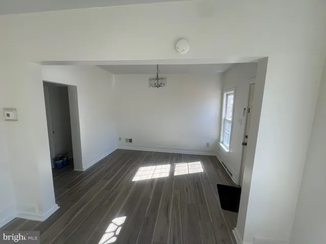 wooden floor in an empty room with a fireplace
