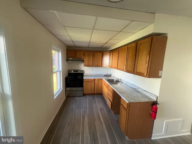 a kitchen with a sink and wooden cabinets