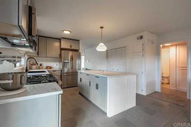 a kitchen that has a lot of cabinets in it