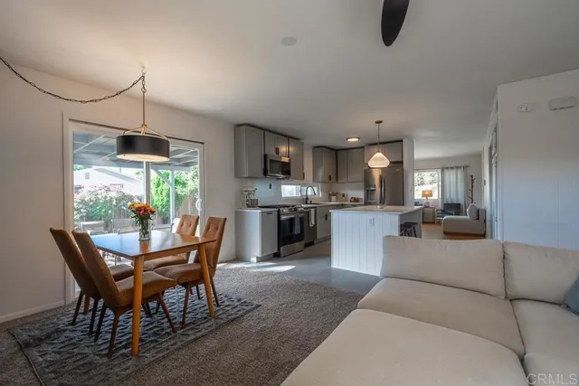 a living room with furniture and a kitchen view