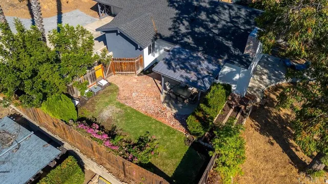 a view of yard from deck with patio