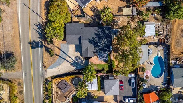 an aerial view of a residential building and car parked on street side