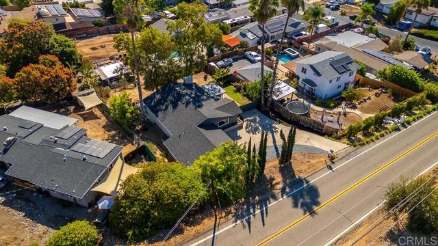 an aerial view of a house with a yard and potted plants