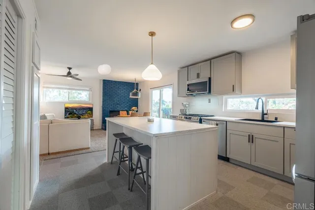 a kitchen with a sink stove and microwave