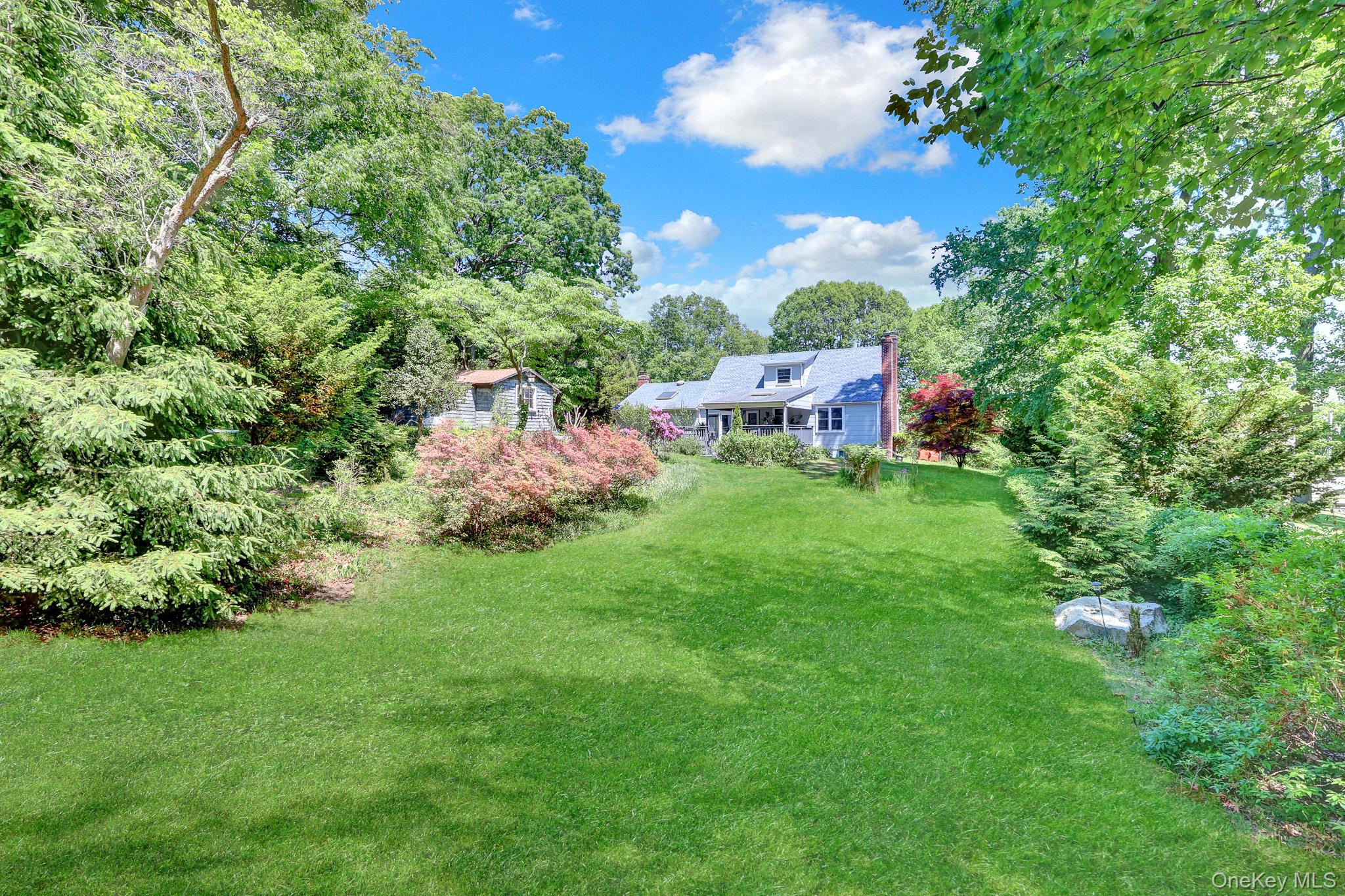 100 Elwood Road Northport, NY 11768 - Photo 27 of 39 Expansive green lawn with mature trees and diverse landscaping