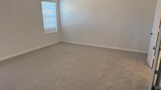 a spacious bathroom with a double vanity sink and a mirror