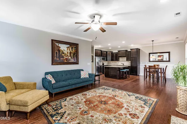 a living room with furniture rug and wooden floor