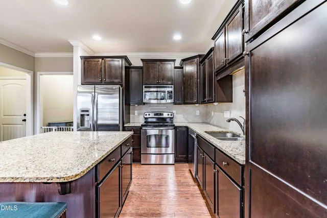 an open kitchen with a table and chairs in it