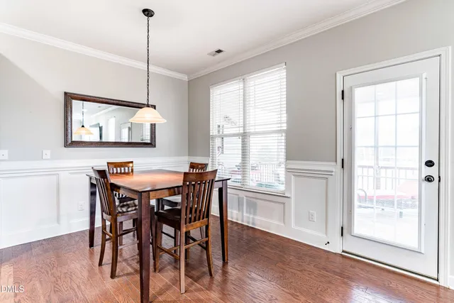 a kitchen with granite countertop cabinets table and chairs
