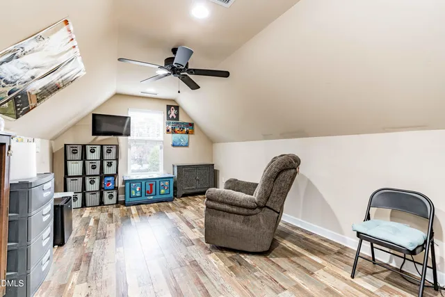 a bathroom with a granite countertop sink a toilet and a mirror