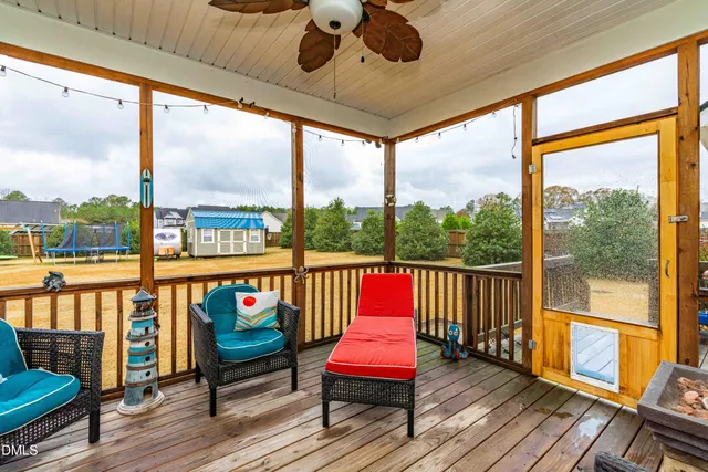 a balcony with furniture and wooden floor