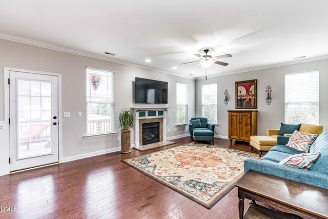 a living room with furniture a fireplace and a flat screen tv