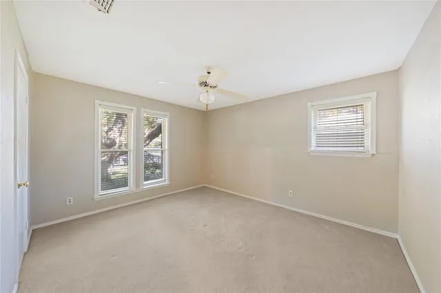 an empty room with windows and closet