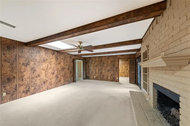 a view of a livingroom with a fireplace and window