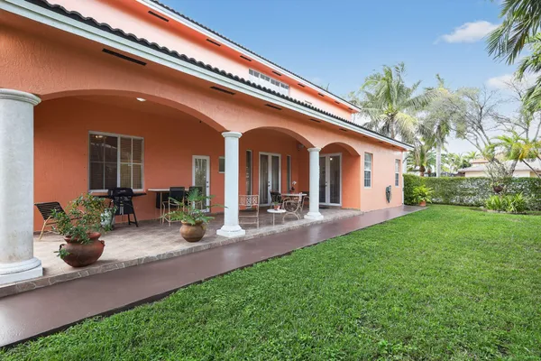 a front view of a house with patio and garden