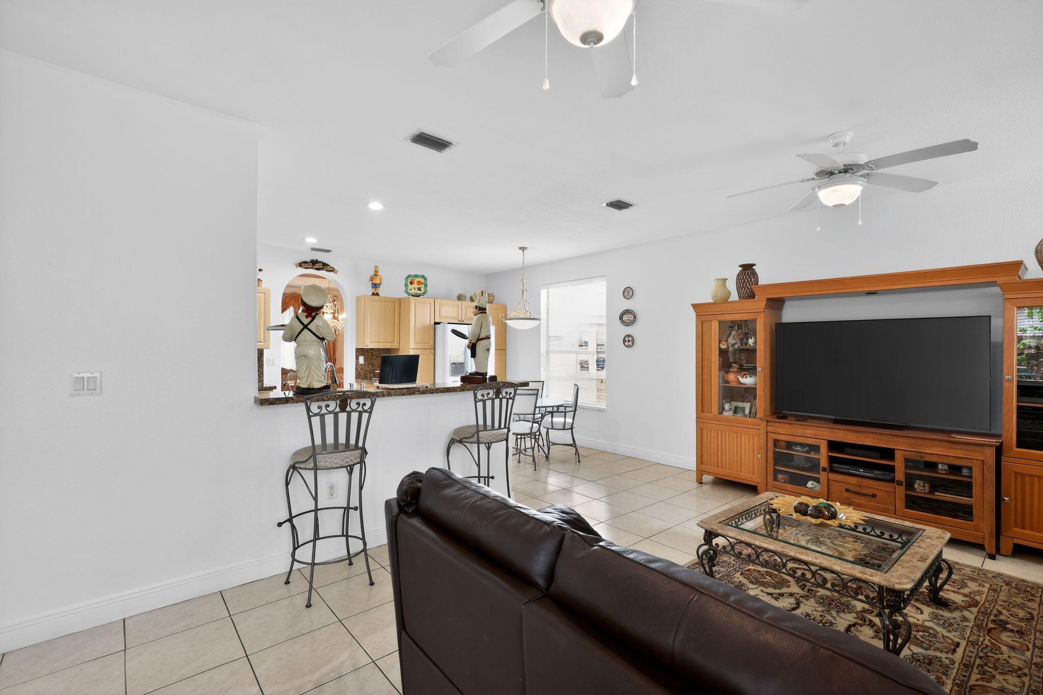 16613 Northwest 77th Path Miami Lakes, FL 33016 - Photo 12 of 41 a living room with furniture and a flat screen tv