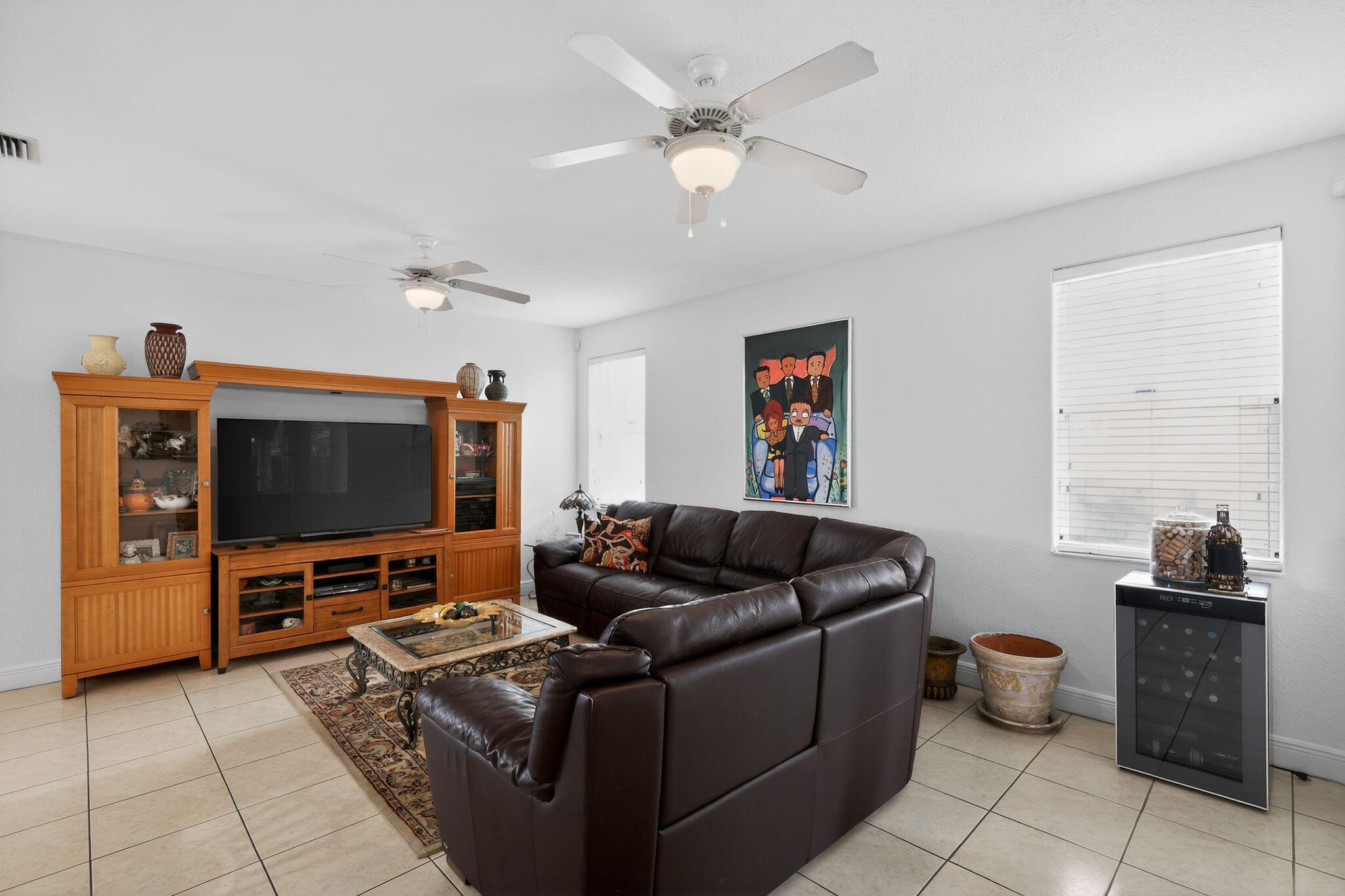 16613 Northwest 77th Path Miami Lakes, FL 33016 - Photo 13 of 41 a living room with furniture and a flat screen tv