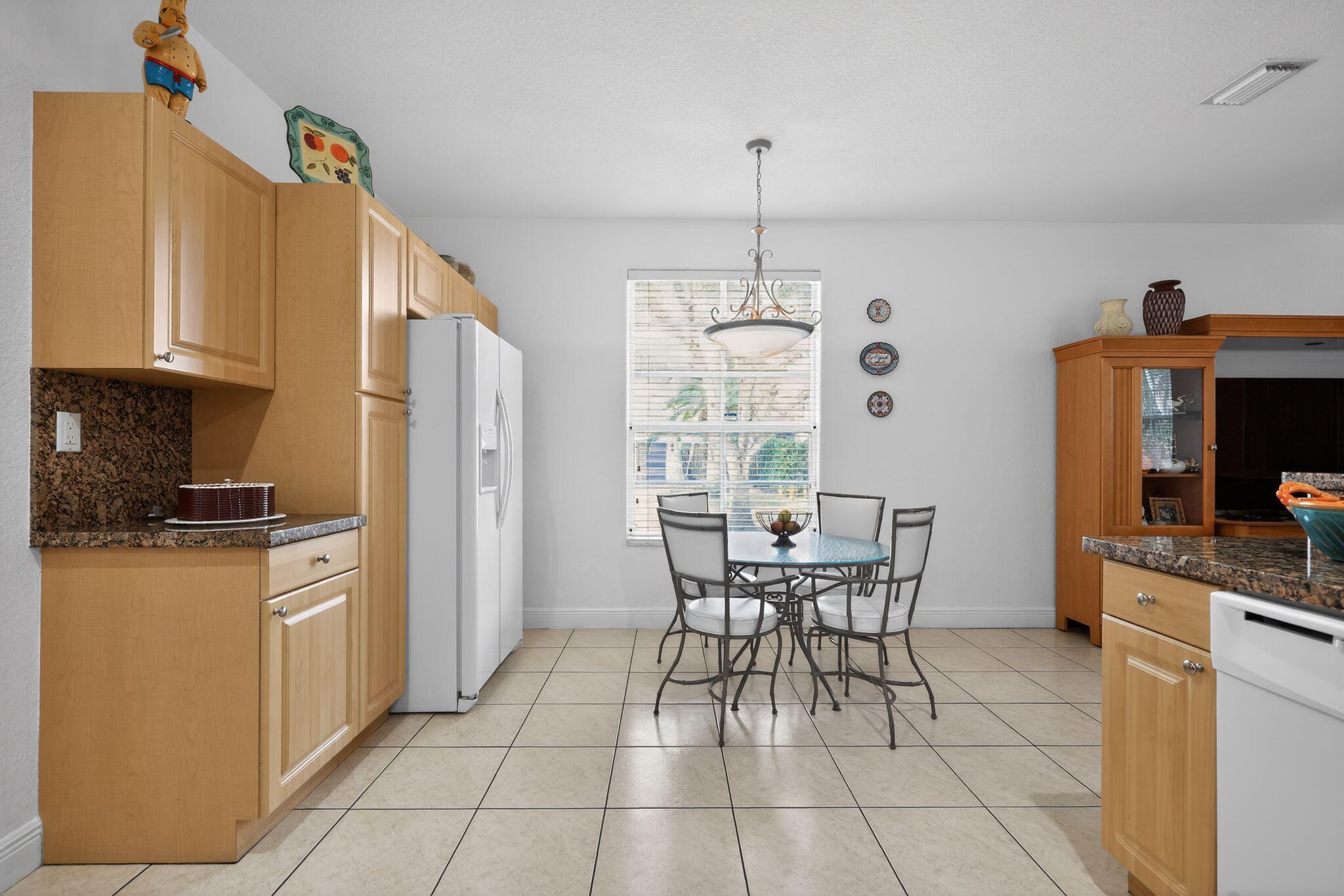 16613 Northwest 77th Path Miami Lakes, FL 33016 - Photo 15 of 41 a kitchen with stainless steel appliances granite countertop a stove top oven a sink a counter space and cabinets