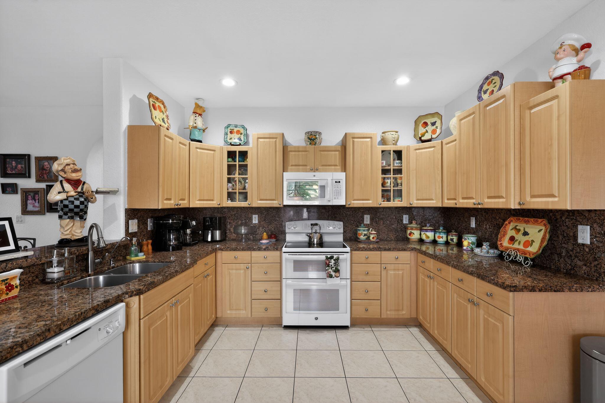 16613 Northwest 77th Path Miami Lakes, FL 33016 - Photo 16 of 41 a kitchen with stainless steel appliances a stove sink and cabinets