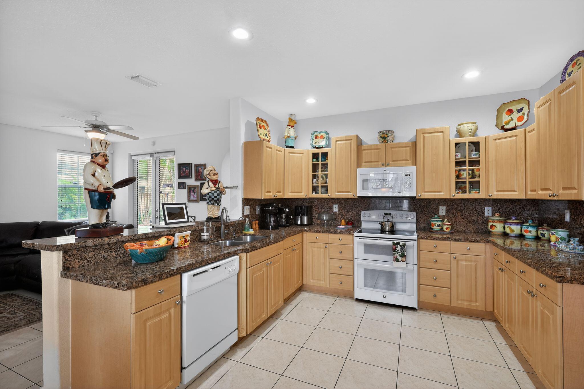 16613 Northwest 77th Path Miami Lakes, FL 33016 - Photo 17 of 41 a kitchen with stainless steel appliances granite countertop a stove sink and cabinets