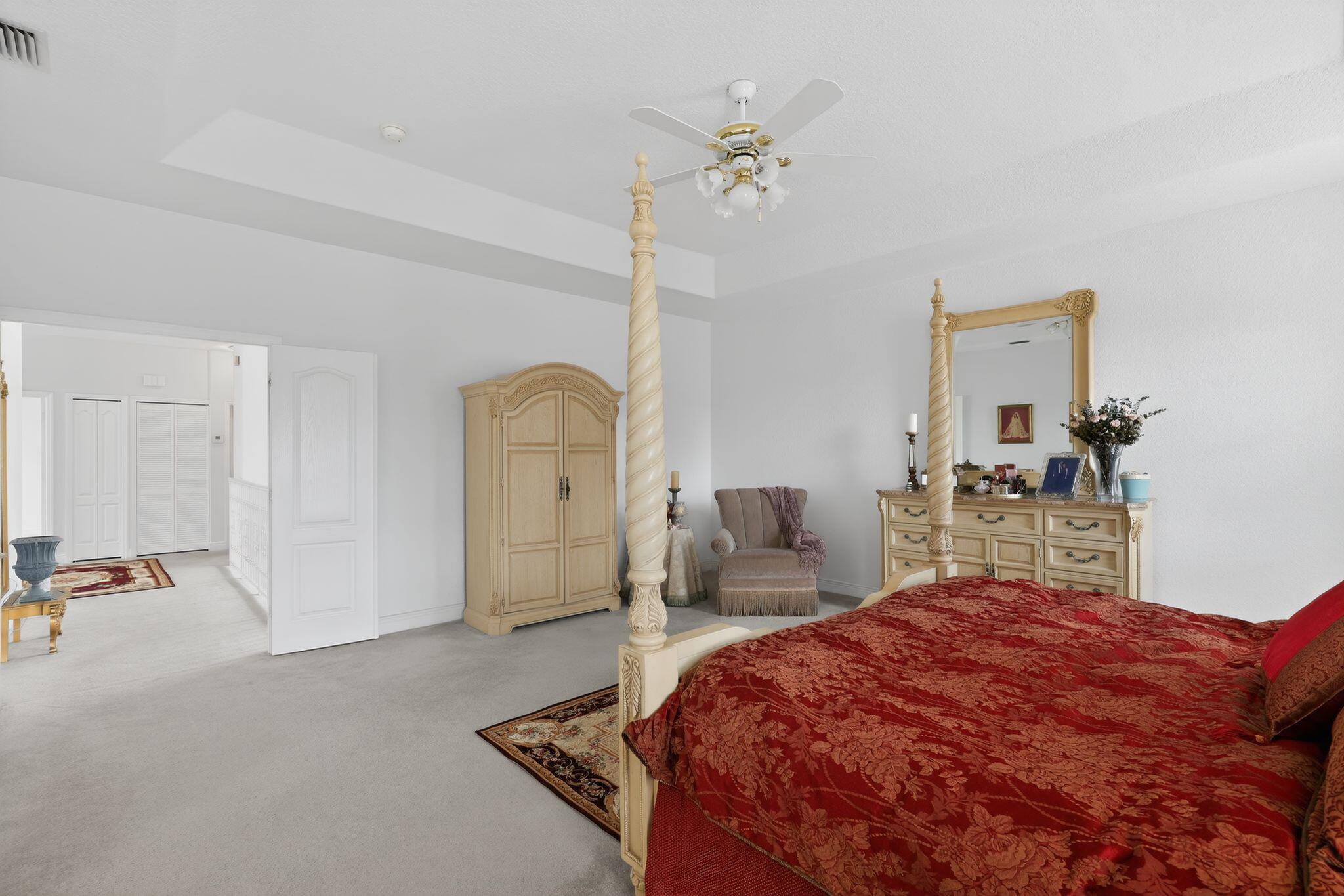 16613 Northwest 77th Path Miami Lakes, FL 33016 - Photo 21 of 41 a bedroom with a bed and a chandelier