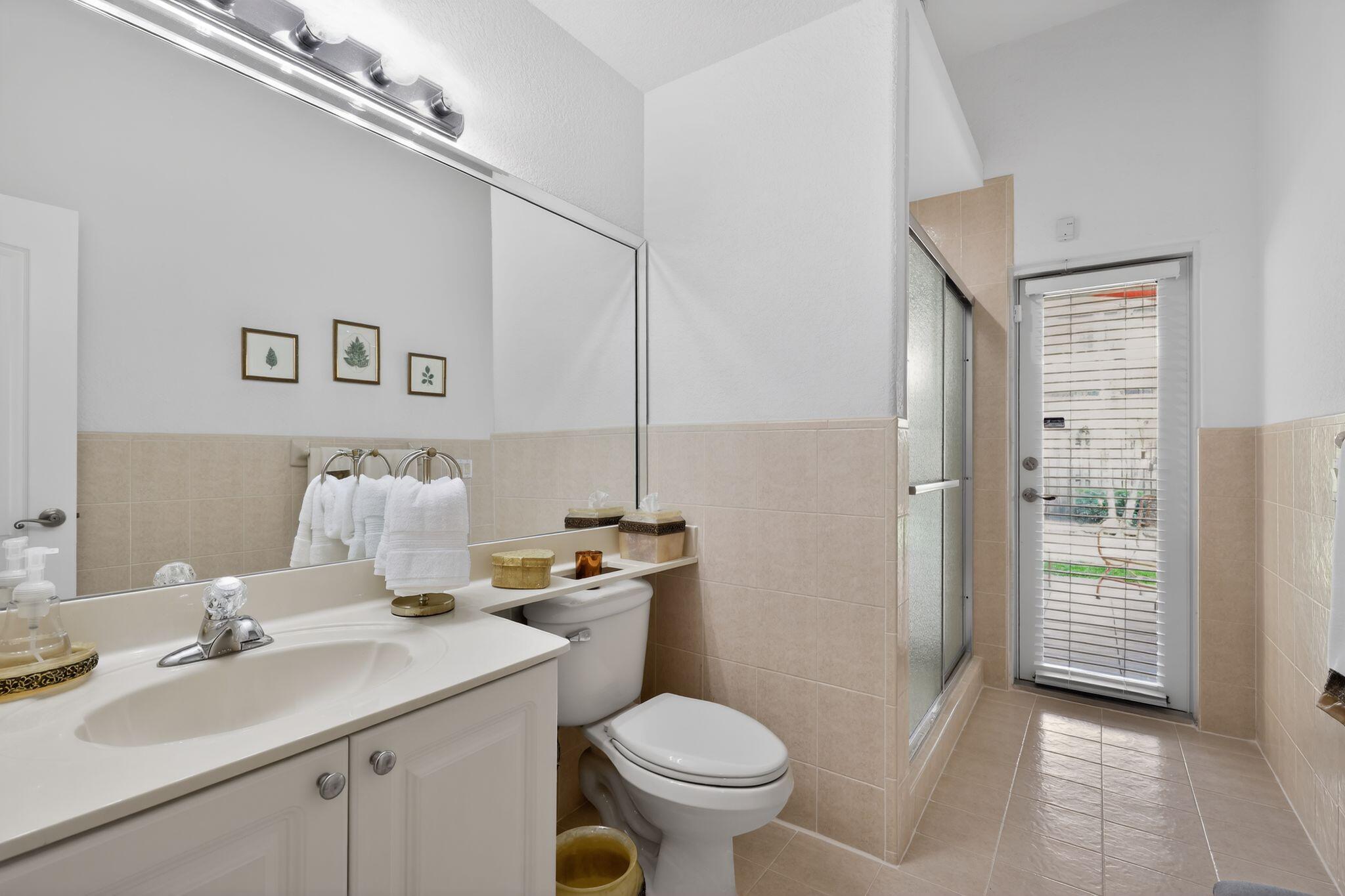 16613 Northwest 77th Path Miami Lakes, FL 33016 - Photo 25 of 41 a bathroom with a toilet sink vanity granite and shower