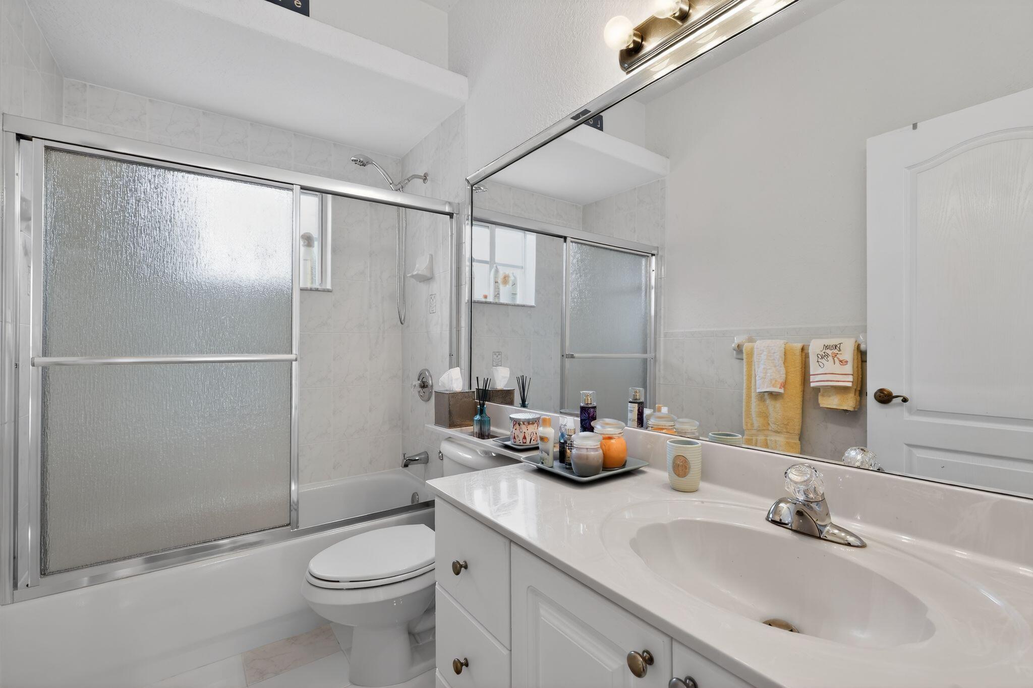 16613 Northwest 77th Path Miami Lakes, FL 33016 - Photo 26 of 41 a bathroom with a double vanity sink toilet and shower