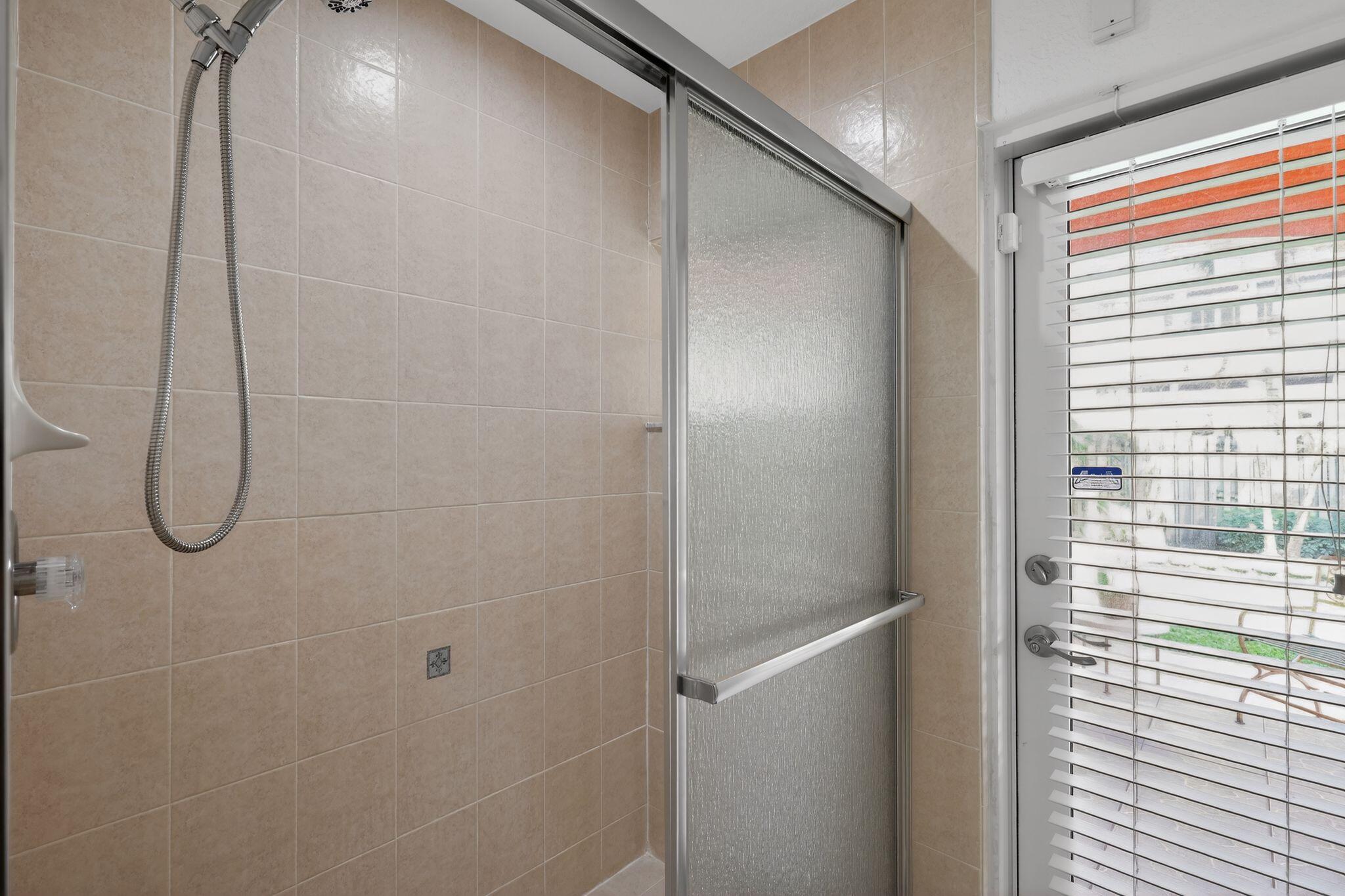 16613 Northwest 77th Path Miami Lakes, FL 33016 - Photo 27 of 41 a bathroom with a glass shower door