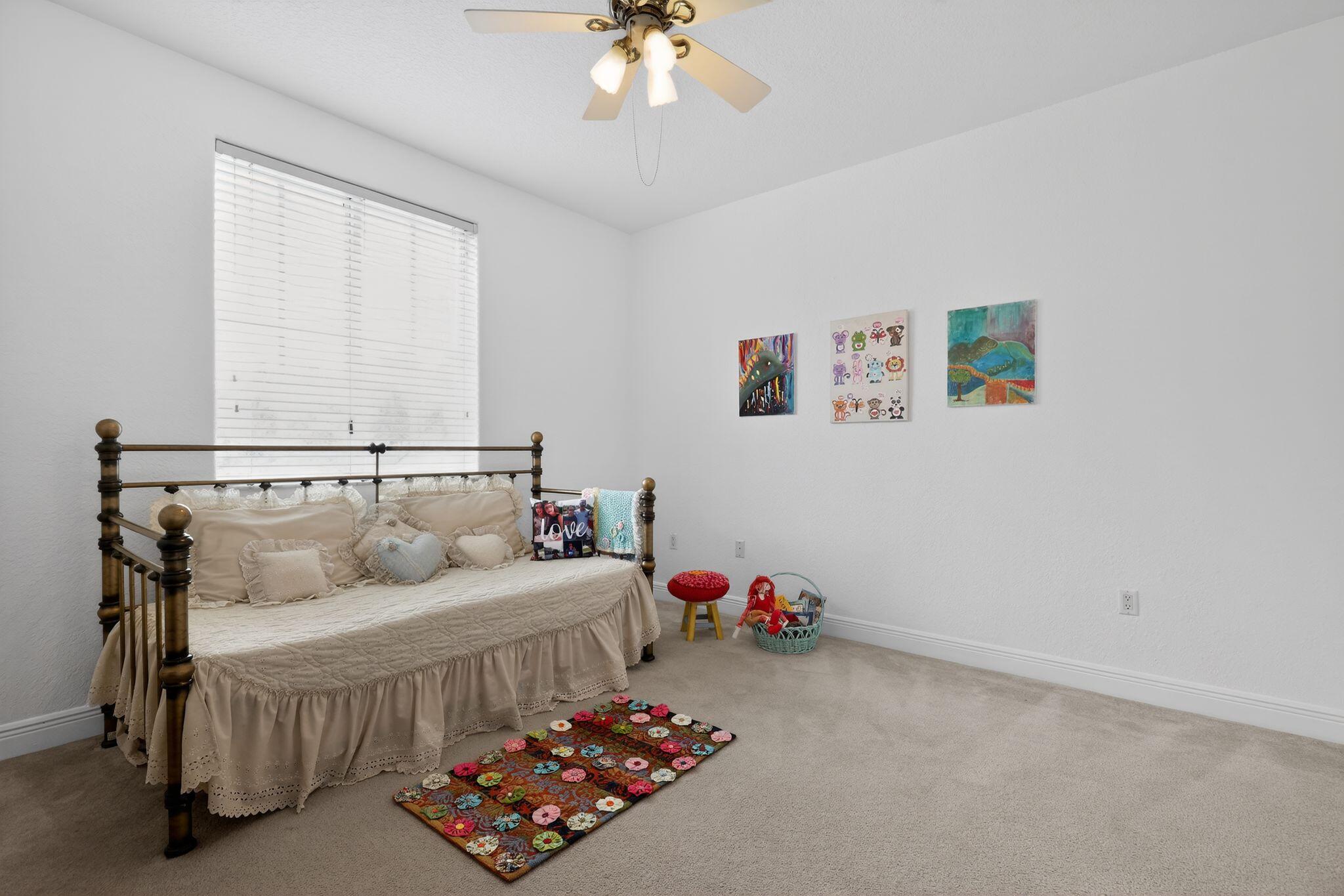 16613 Northwest 77th Path Miami Lakes, FL 33016 - Photo 32 of 41 a bedroom with a bed and a chandelier