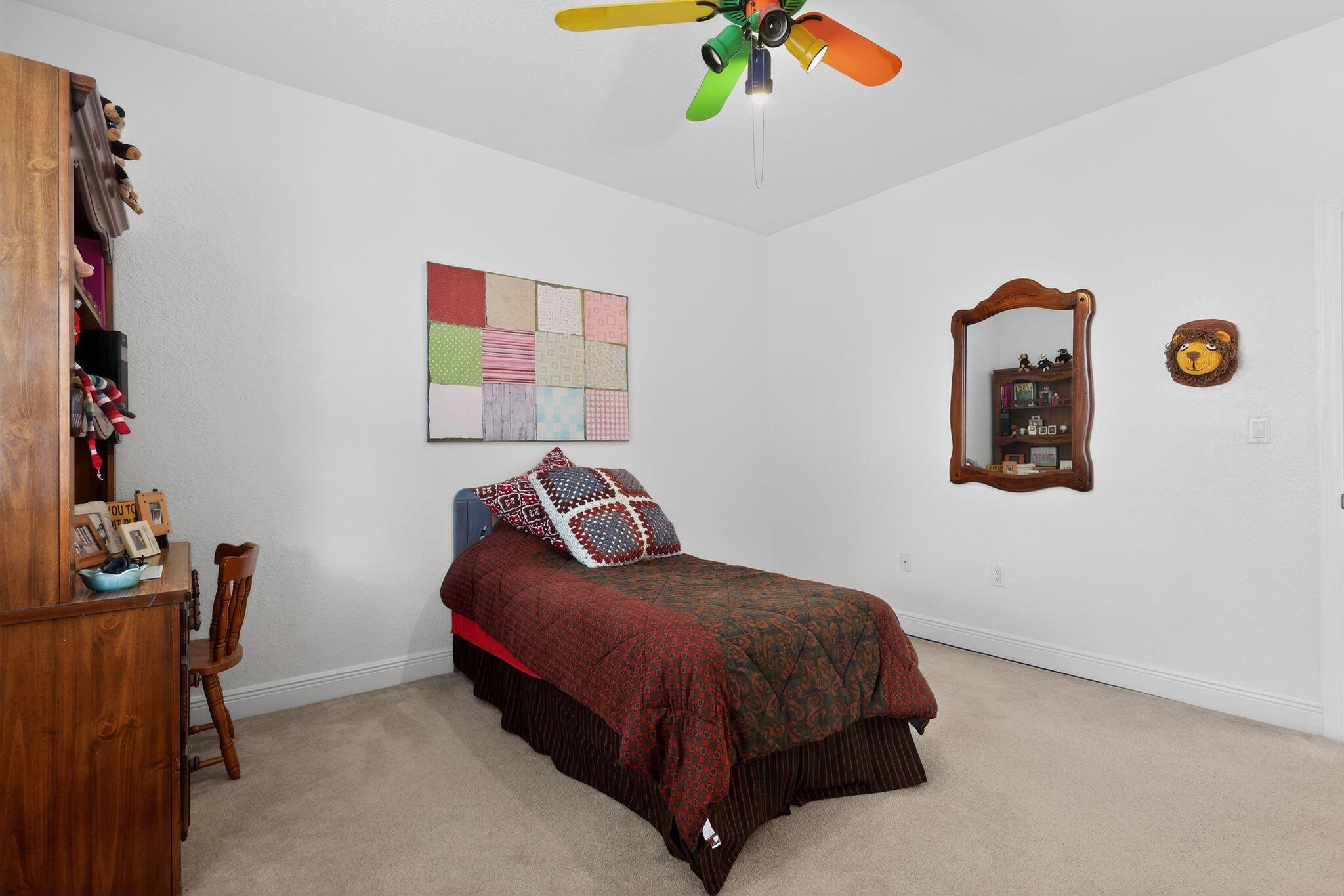 16613 Northwest 77th Path Miami Lakes, FL 33016 - Photo 33 of 41 a bedroom with a bed and a chandelier