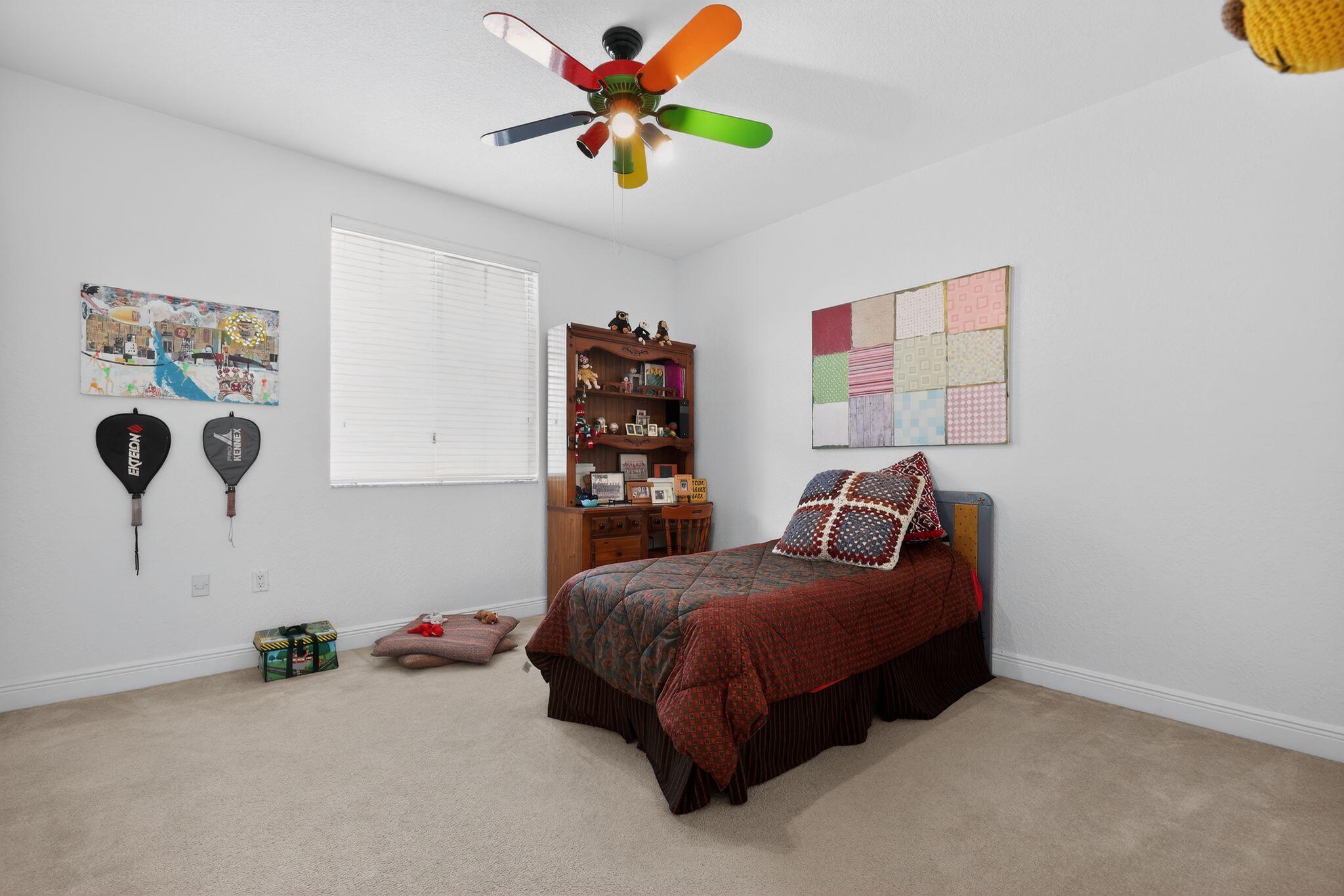 16613 Northwest 77th Path Miami Lakes, FL 33016 - Photo 34 of 41 a bedroom with a bed and a chandelier