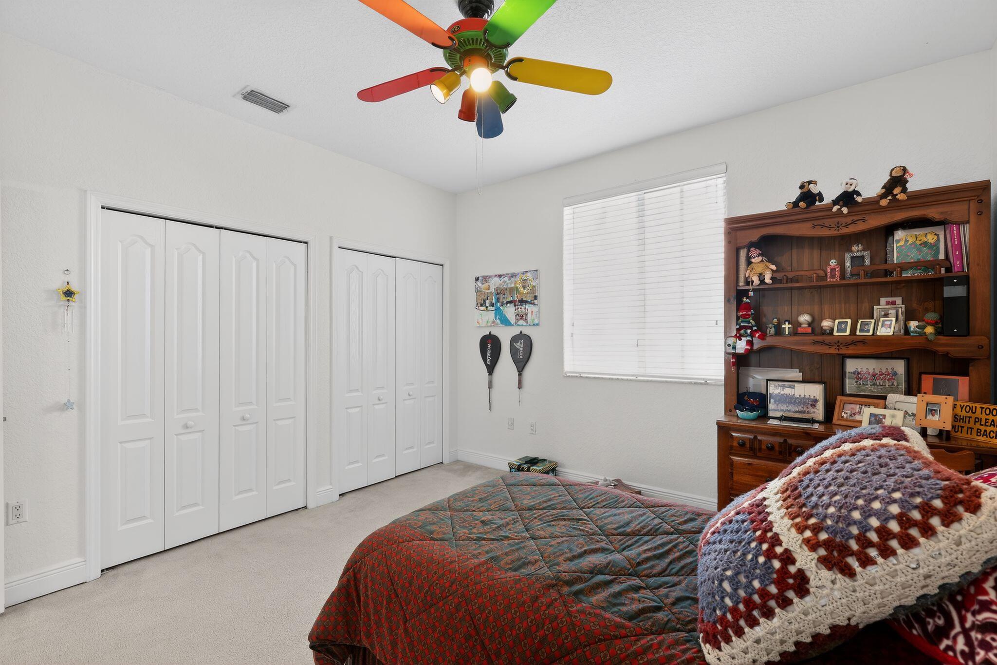 16613 Northwest 77th Path Miami Lakes, FL 33016 - Photo 35 of 41 a bedroom with a bed and a book shelf