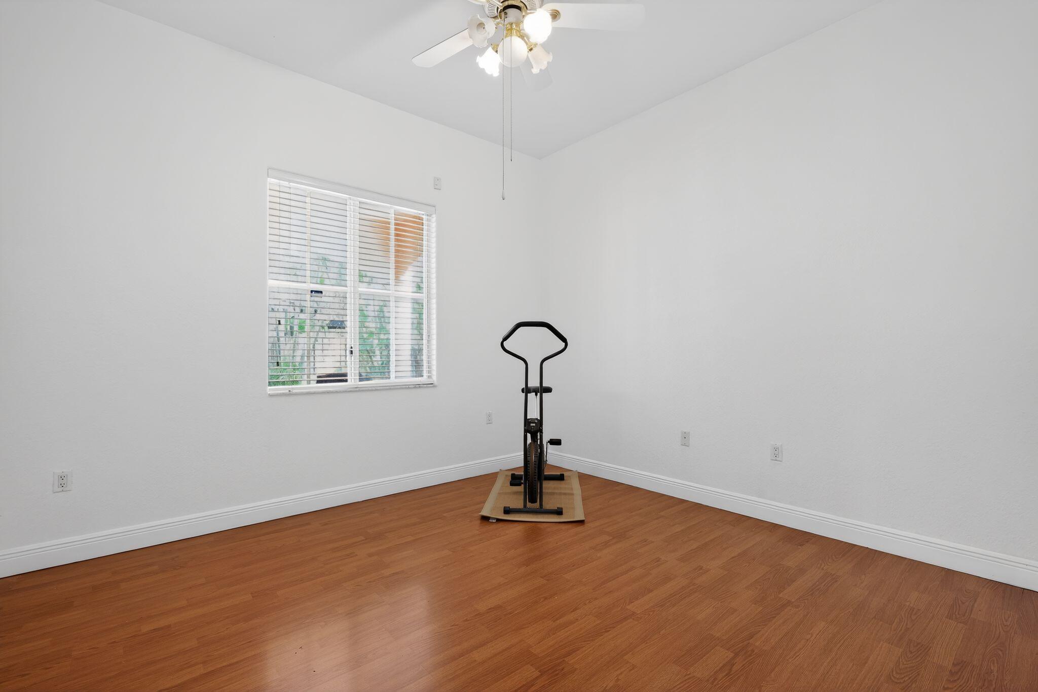16613 Northwest 77th Path Miami Lakes, FL 33016 - Photo 36 of 41 a view of a room with gym equipment and a chandelier