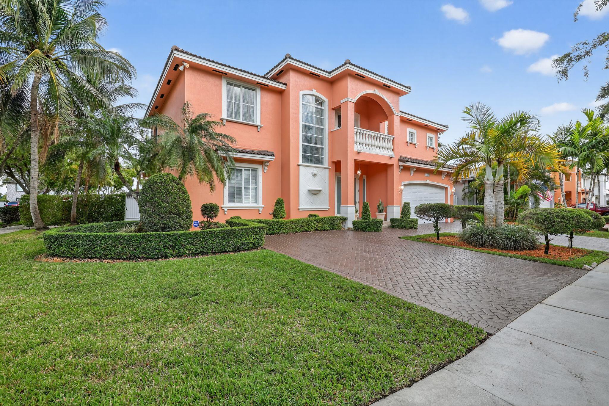 16613 Northwest 77th Path Miami Lakes, FL 33016 - Photo 5 of 41 a front view of a house with a yard and potted plants