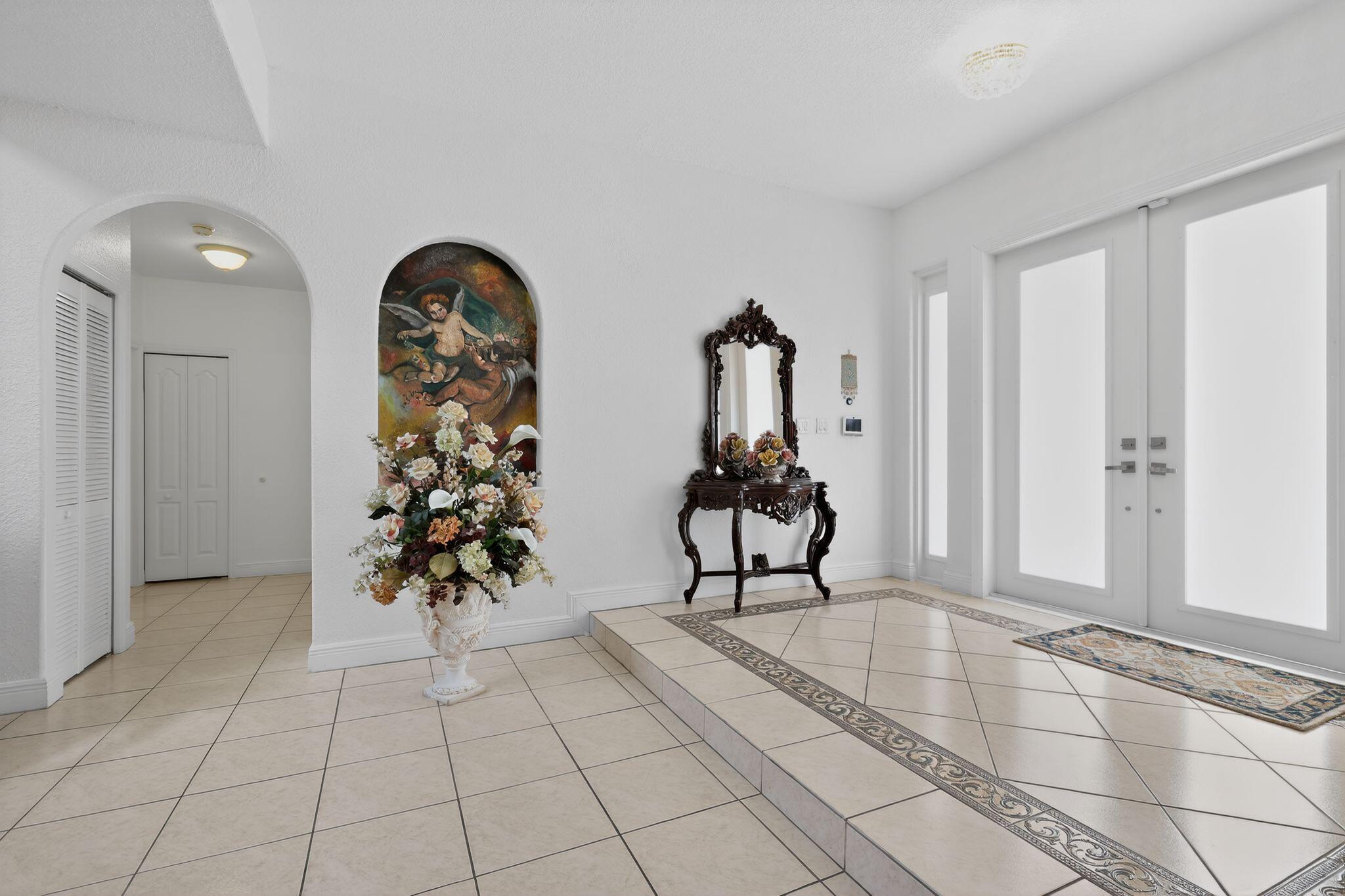 16613 Northwest 77th Path Miami Lakes, FL 33016 - Photo 10 of 41 a view of entryway with a flower pot and a rug