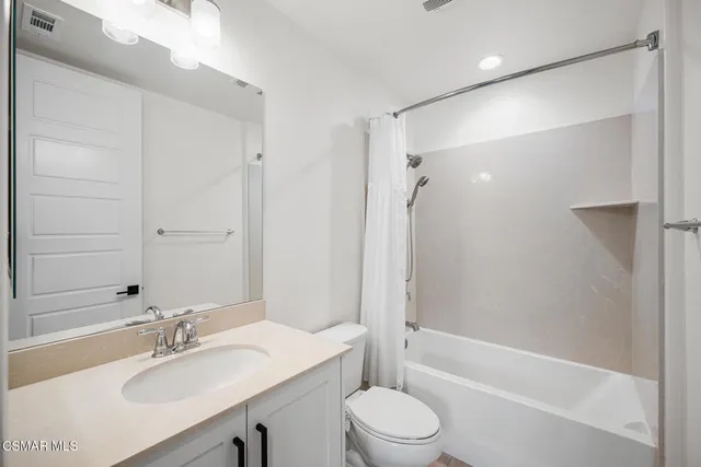 a view of staircase with railing and white walls