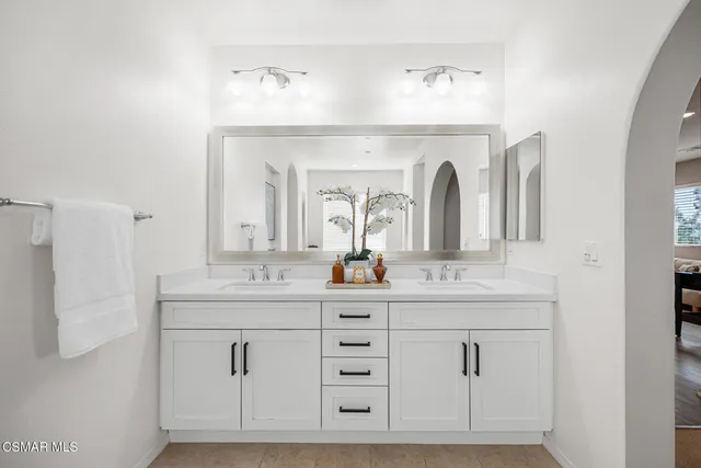 a spacious bathroom with a granite countertop sink mirror and shower