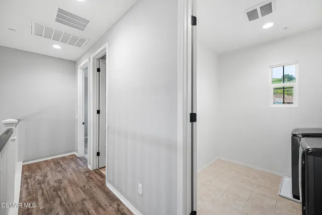 a view of a terrace with chairs and a barbeque