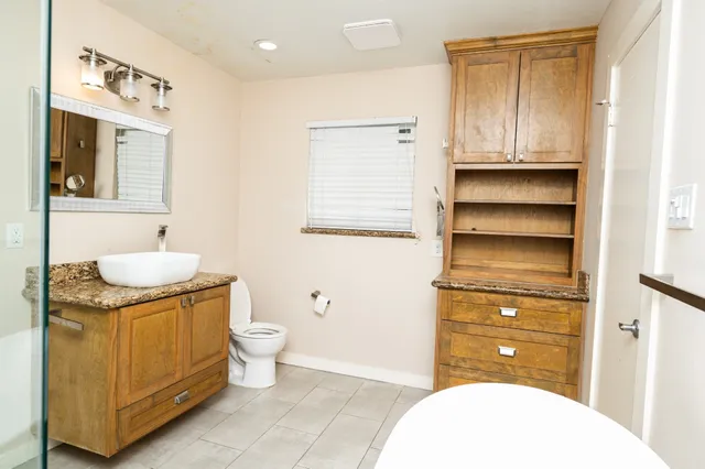 a bathroom with a sink a toilet and vanity